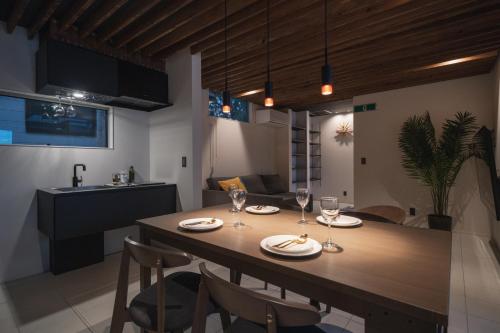 a kitchen and dining room with a table and chairs at Okinawa Villa KILOHANA in Inbu