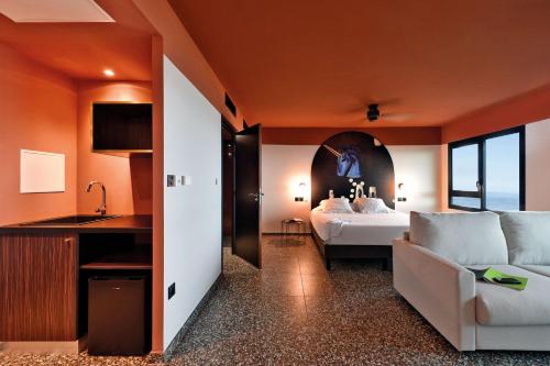 a hotel room with a bed and a couch at DINA MORGABINE SAINT DENIS in Saint-Denis