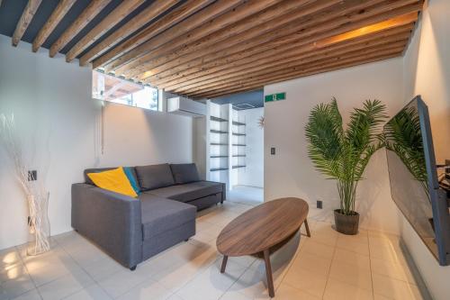 a living room with a couch and a table at Okinawa Villa KILOHANA in Inbu