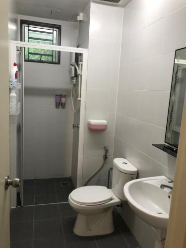 a bathroom with a toilet and a sink and a shower at Taiping Rain Town Homestay太平雨城名宿 two car park in Taiping