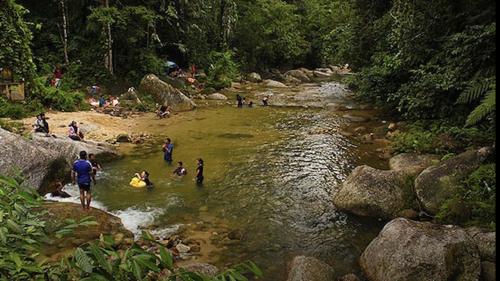 a group of people playing in a river at Taiping Rain Town Homestay太平雨城名宿 two car park in Taiping