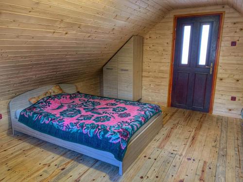 a bedroom with a bed in a wooden room at Brvnare Cirkovic in Zlatibor