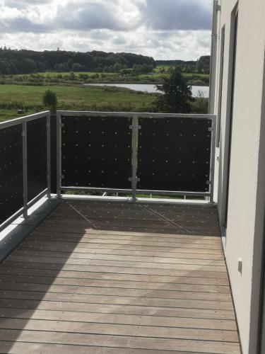 a balcony with a view of the water at Hus med søudsigt in Brabrand