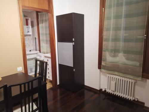 a kitchen with a black and white refrigerator in a room at Soleneve in Passo del Tonale