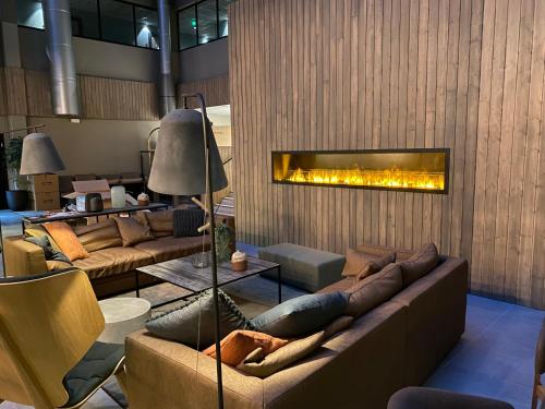 a living room filled with furniture and a fire place at Skyline Airport Hotel in Vantaa