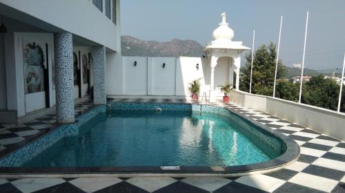 a swimming pool on the side of a building at Regenta Central Mewargarh, Near Biological park in Udaipur