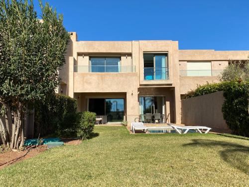 un grande edificio con un cortile con tavolo e sedie di Villa prestige a Marrakech