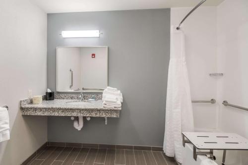 a bathroom with a sink and a mirror at MainStay Suites in Union City