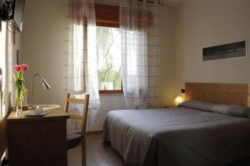 a bedroom with a bed and a sink and a window at I Due Orfici in Cona