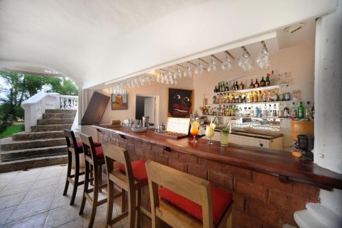a bar with chairs and a counter in a room at Hotel Atlantis in Las Terrenas