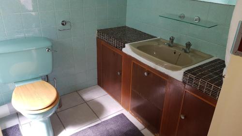 a bathroom with a toilet and a sink at Accommodation@Park1285 in Pretoria