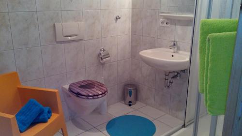 a bathroom with a toilet and a sink and a shower at Ferienwohnung - Ferien in der Grub in Lindau