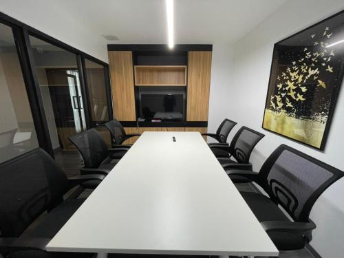a conference room with a white table and chairs at Gate43 Airport Hotel in Lat Krabang