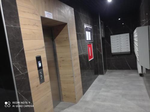 a elevator in a building with a wall of wood at Дуже файна квартира в самому центрі!!!!Переконайся!! in Rivne