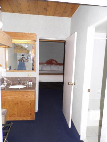 a bathroom with a sink and a bunk bed at America's Best Value Inn Sandpoint in Sandpoint