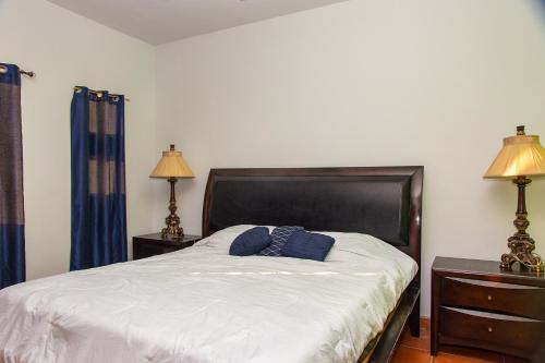 a bedroom with a bed with blue pillows on it at Bella Vista 7 in Puerto Peñasco