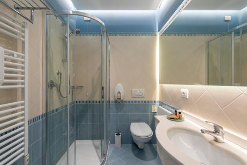 a bathroom with a shower and a sink and a toilet at Hotel Locanda Al Piave ***S in San Donà di Piave