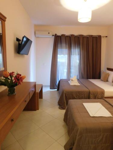 a hotel room with two beds and a television at Anna house 3 in Sarti