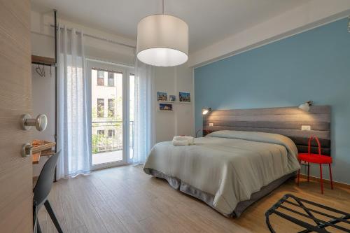 ein Schlafzimmer mit einem Bett und einem großen Fenster in der Unterkunft Meridiana B&B in Palermo