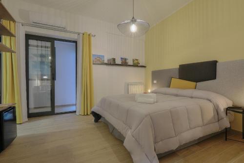 a bedroom with two beds and a window at Meridiana B&B in Palermo
