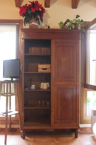 a wooden cabinet with a tv in a room at Xarma in Lezo