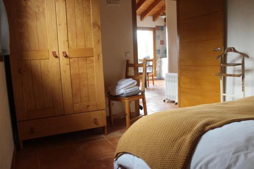 a bedroom with a bed and a wooden cabinet at Xarma in Lezo
