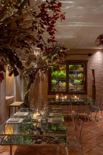 a dining room with tables and chairs and windows at Hotel Locanda Al Piave ***S in San Donà di Piave