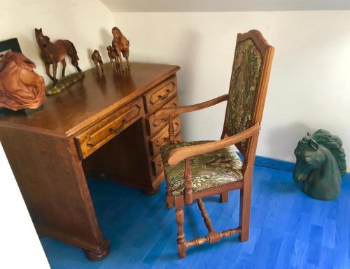 a wooden desk with a chair and figurines on it at venez visitez calais in Calais