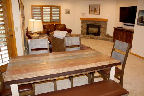 a living room with a table and a fireplace at Woods Manor #302-A - Close to Main Street - Access to Indoor Hot Tub and Shuttle in Breckenridge