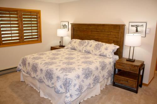 a bedroom with a bed and two night stands with lamps at Woods Manor #302-A - Close to Main Street - Access to Indoor Hot Tub and Shuttle in Breckenridge