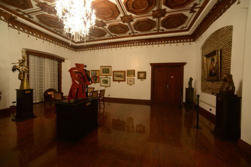 a large room with a statue in the middle of it at Hotel Luna in Vigan