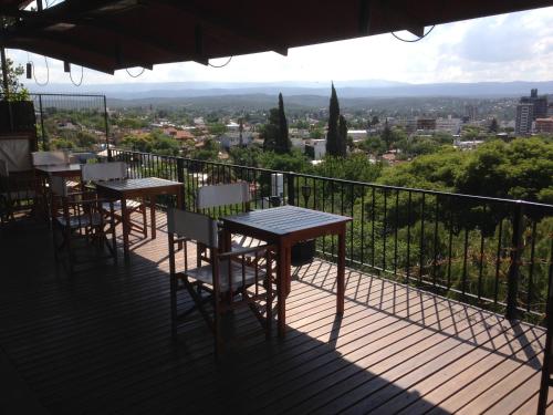 two tables and chairs on a balcony with a view at Casa Alta Hotel Boutique & Spa - Solo Adultos in Villa Carlos Paz