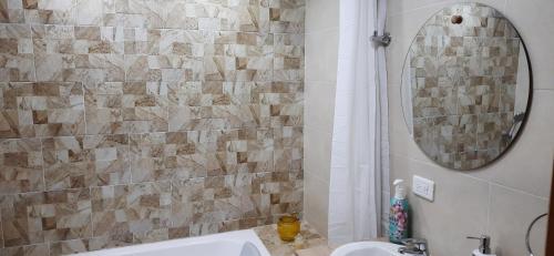a bathroom with a sink and a mirror at Cabaña Rodamonte - Neusa in Cogua