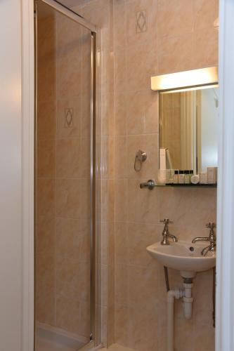a bathroom with a shower and a sink at The Llanelwedd Arms Hotel in Builth Wells