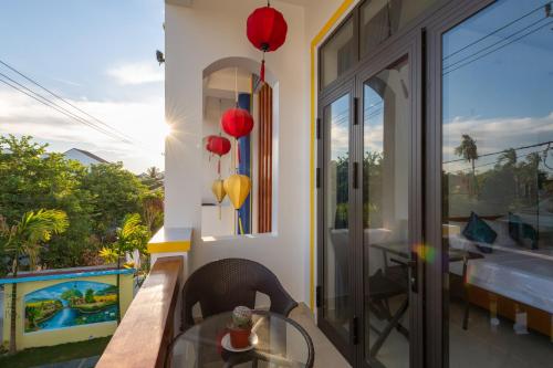 a room with a table and a view of a pool at Hoi An Village Villa in Hoi An