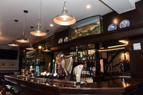 a bar with a mirror above the bar at The Llanelwedd Arms Hotel in Builth Wells