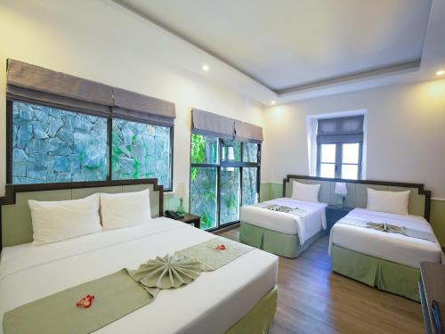 Кровать или кровати в номере Paralia Khem Beach Phu Quoc Hotel
