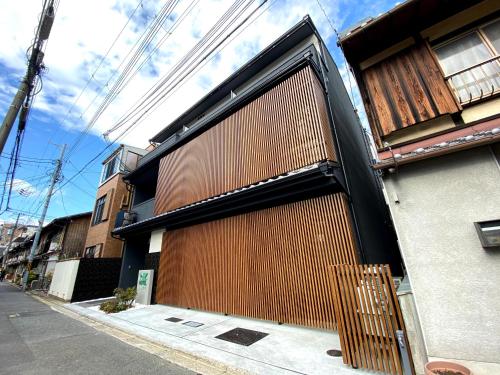a building with a large wooden garage door at HIZ HOTEL Gion-Shirakawa in Kyoto