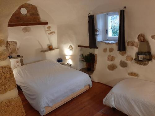 a bedroom with two beds and a window at Guesthouse Contrada Bolla in Finale Ligure