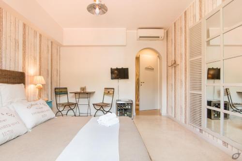 a bedroom with a bed and a table with chairs at Le Camere Pietrasantine - Centro Storico in Pietrasanta