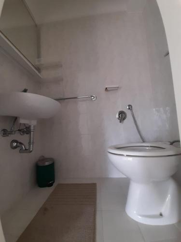 a white bathroom with a toilet and a sink at B&B InCentro in Ripatransone