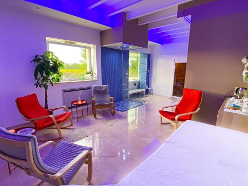 a dining room with red chairs and a white table at Tenuta Vigna del Noce in Corato