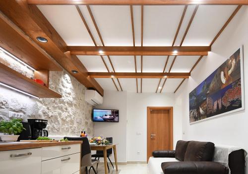 Studio Apartment San Matteo in Dubrovnik في دوبروفنيك: غرفة معيشة بسقف مع عوارض خشبية