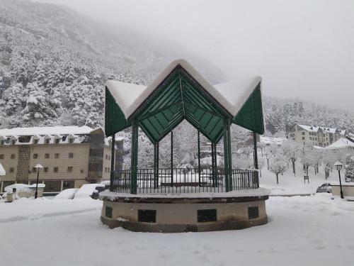 a monument covered in snow in a city at Apartamento de montaña "Nueva Canfranc" in Canfranc-Estación