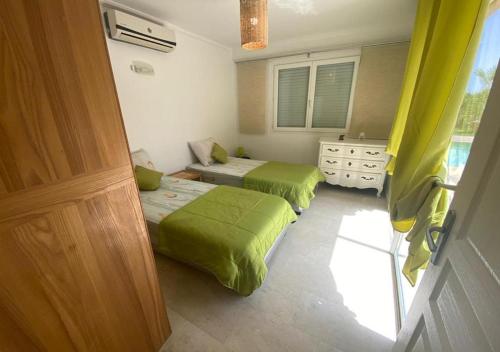 En eller flere senge i et værelse på Villa nahellan