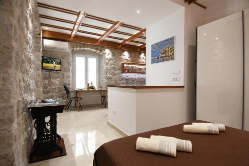 a bedroom with a bed and a desk in a room at Studio Apartment San Marino in Dubrovnik in Dubrovnik