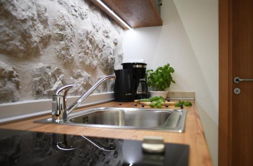 a kitchen with a sink and a counter at Studio Apartment San Marino in Dubrovnik in Dubrovnik