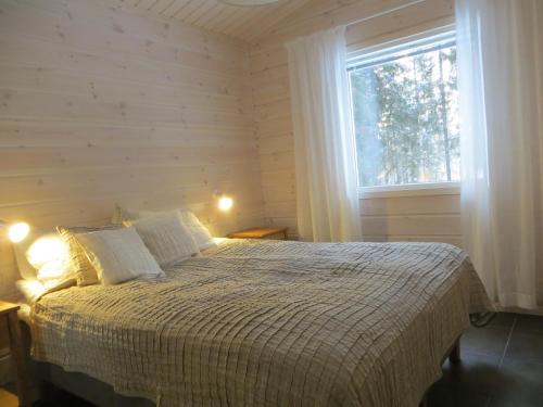 a bedroom with a bed and a window at Ankkuri Raijan Aitta in Mikkeli
