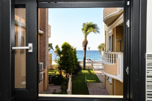 a view of the ocean from a house door at Ixia Breeze 3 in Ixia