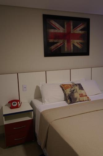 a hotel room with two beds and a flag on the wall at Pak Suítes Hotel in Luis Eduardo Magalhaes